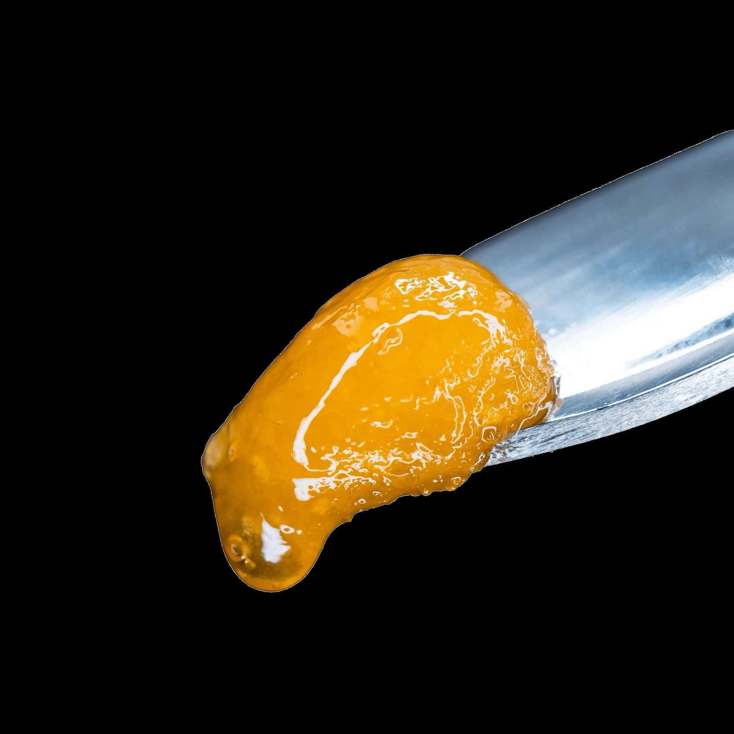 Donny Burger Live Resin THCa Diamonds on a metal tool, showcasing its rich amber color and sticky texture.