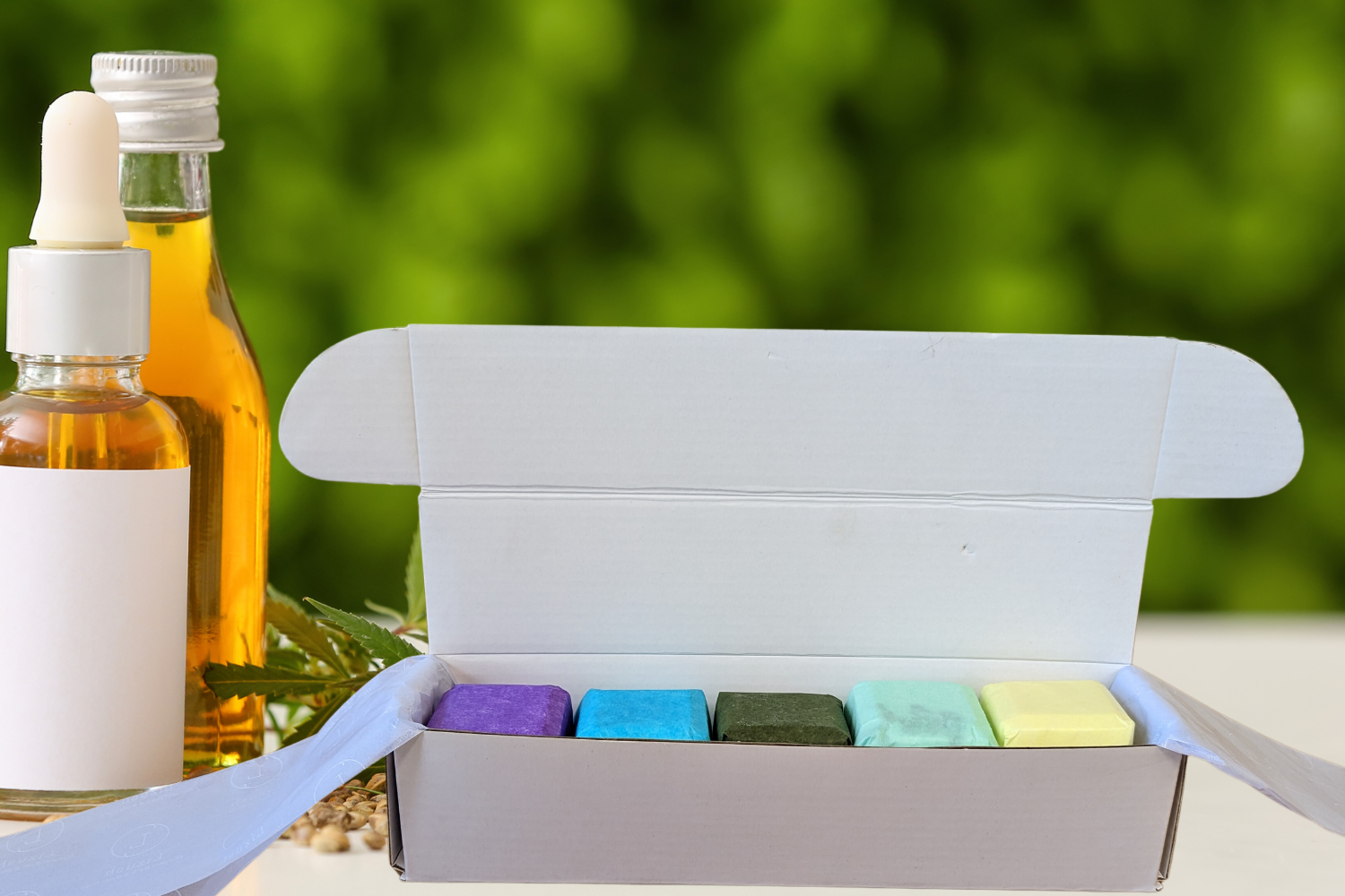 CBD shower steamers gift set with colorful fizzies and essential oil bottle, perfect for a relaxing shower experience.