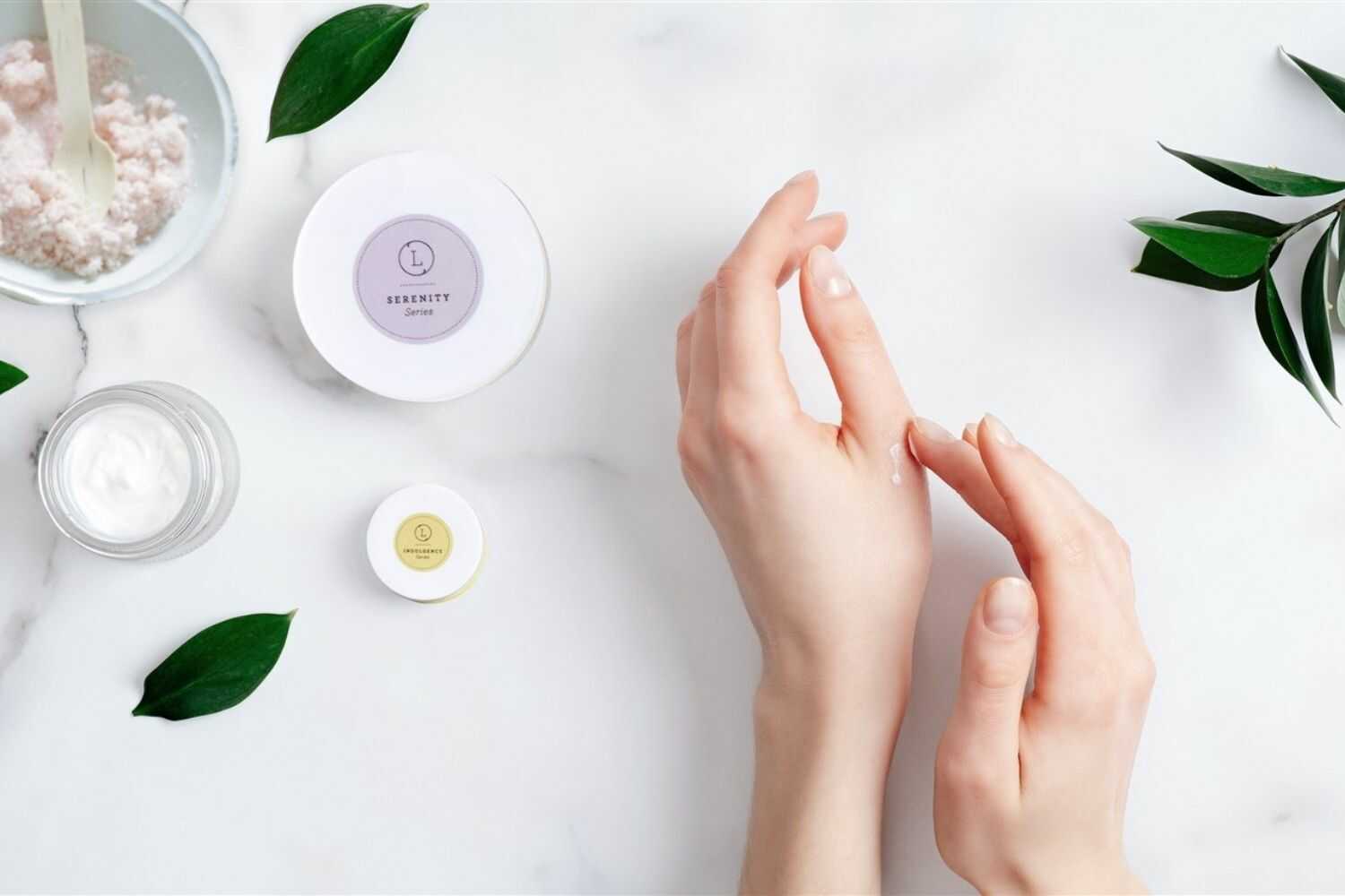 Gently applying CBD Lavender Shea Butter body cream to revitalizing dry skin, surrounded by natural ingredients.