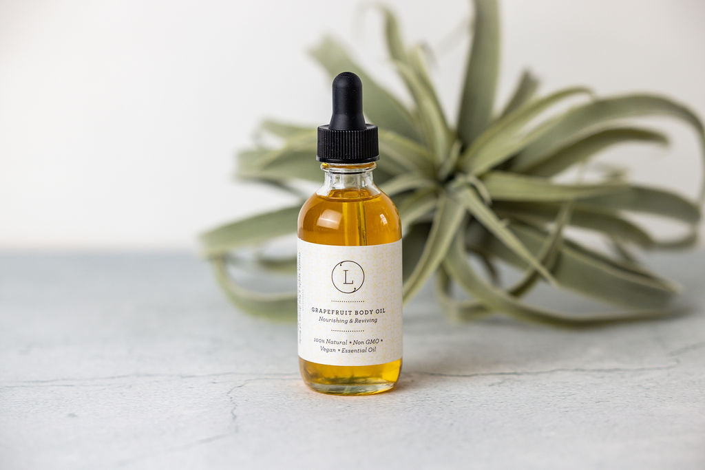 CBD Natural Body Oil in a glass bottle with dropper, featuring grapefruit scent for moisturizing and nourishing the skin.