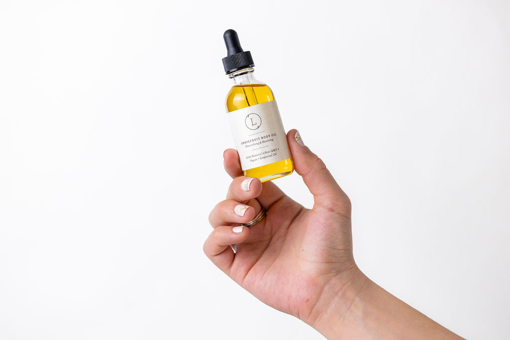 CBD natural body oil in a dropper bottle held in hand, promoting skin hydration and glow.